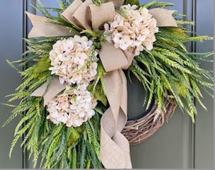 A stunning reuseable seasonal wreath hanging from a door