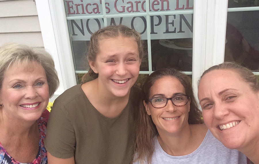 Erica's Garden employees smiling with the grand opening sign behind them