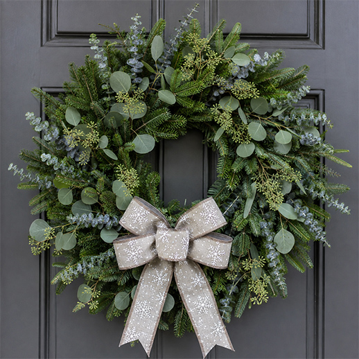 A jubilant and aromatic winter wreath adorning a home doorway
