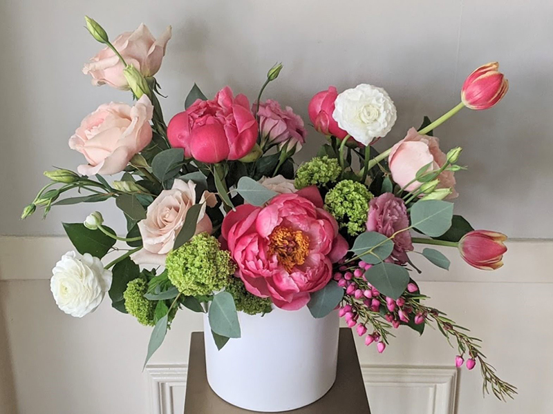 An arrangement bursting with peonies, roses, hydrangea, lisianthus and mixed foliage