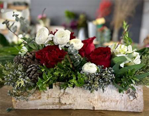 A warm wintery mix of red green and white florals and adornments